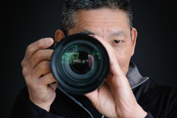 Photographer with lens